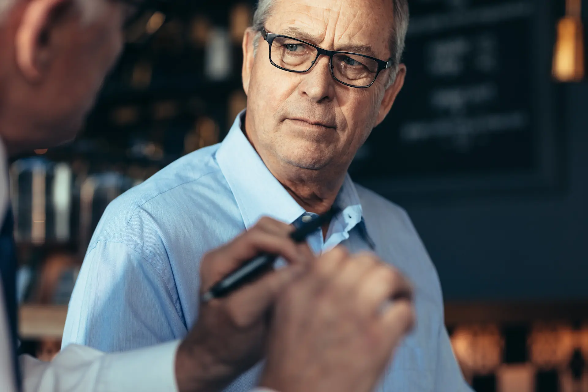 Businessmen discussing issues in cafe
